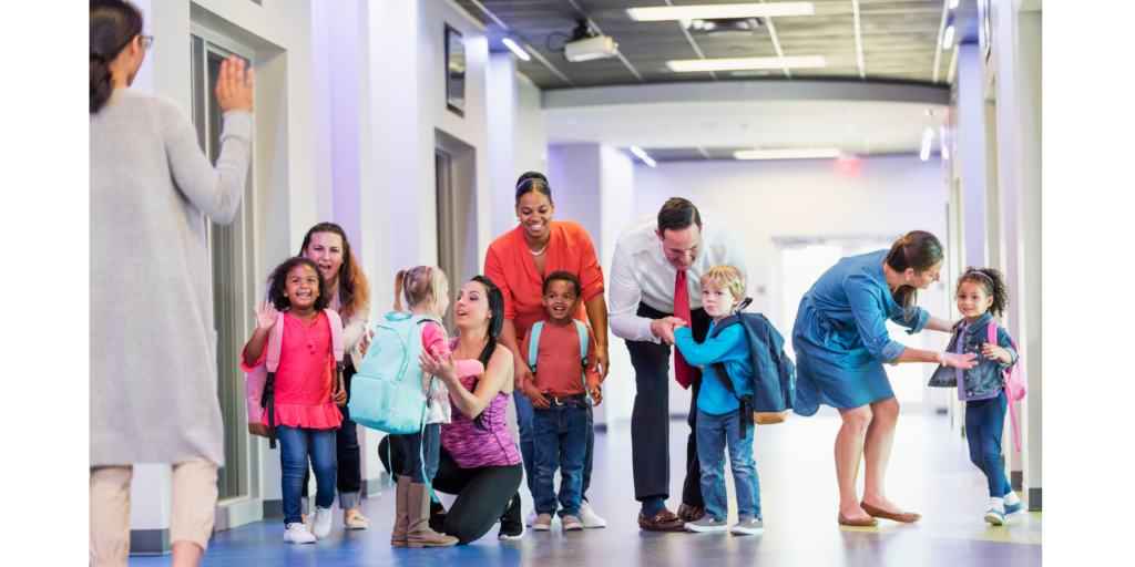 A group of children and adults in a school hallway, highlighting the importance of communication between families and educators.